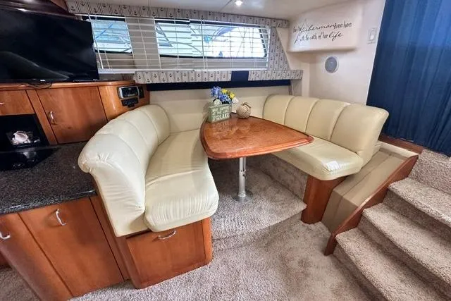 Slide: The Image of Interior of 2004 Carver 360 Mariner yacht with cozy dining area and plush seating. - 25