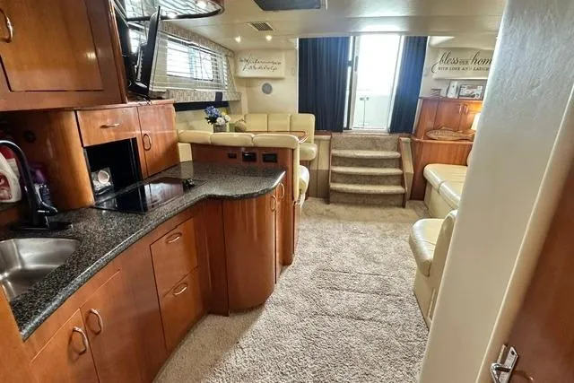 Slide: The Image of Interior of 2004 Carver 360 Mariner yacht with modern kitchen and cozy seating area. - 27