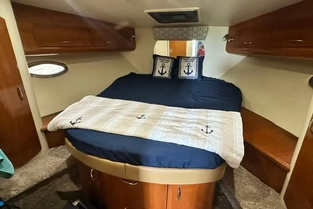 Slide: The Image of Cozy cabin interior of 2004 Carver 360 Mariner with nautical-themed bedding. - 28