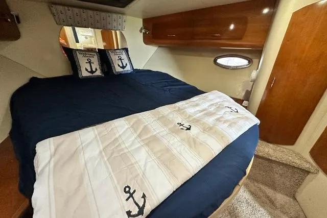 Slide: The Image of Luxurious cabin interior of 2004 Carver 360 Mariner with nautical-themed bedding. - 29