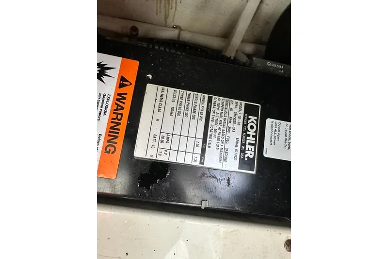 Slide: The Image of Warning label and specifications on Kohler generator in 2004 Carver 360 Mariner. - 35