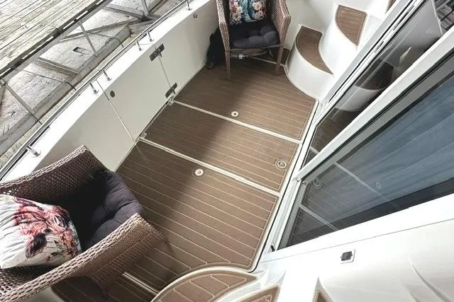 Slide: The Image of 2004 Carver 360 Mariner deck with wicker chairs and cushions. - 6