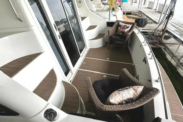 Slide: The Image of 2004 Carver 360 Mariner yacht deck with wicker chairs and wooden flooring. - 8