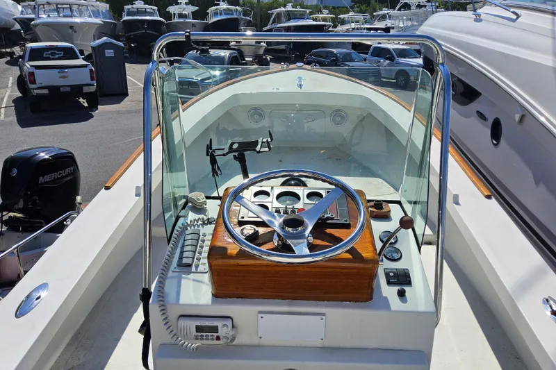 Slide: The Image of 2010 Grey Barn Boatworks North Shore 22 helm with steering wheel and controls. - 11