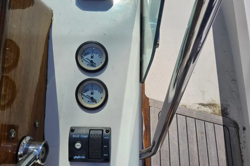 Slide: The Image of Control panel of 2010 Grey Barn Boatworks North Shore 22 with fuel gauges and bilge pump. - 13
