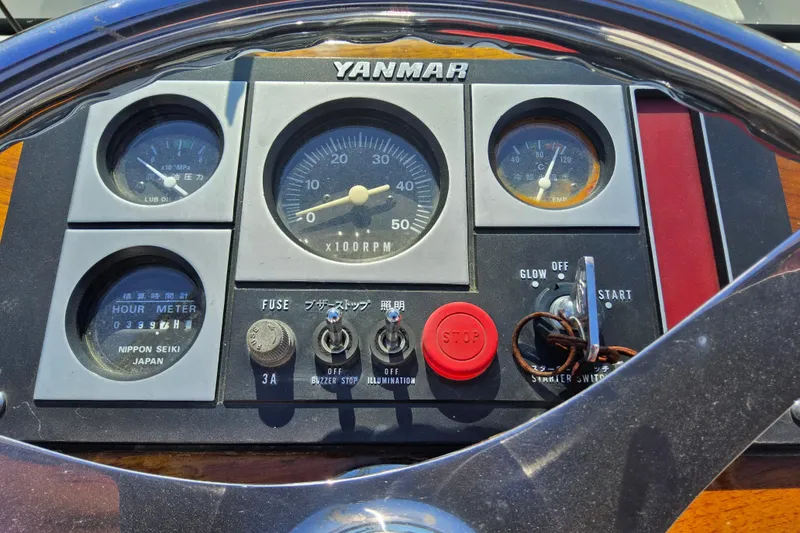 Slide: The Image of Yanmar control panel on 2010 Grey Barn Boatworks North Shore 22, featuring gauges and switches. - 14