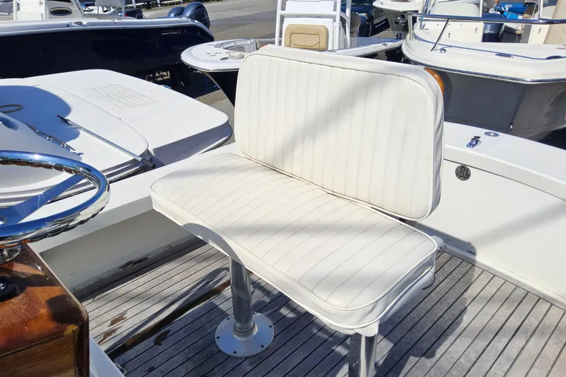 Slide: The Image of White cushioned seat on 2010 Grey Barn Boatworks North Shore 22 boat deck. - 16