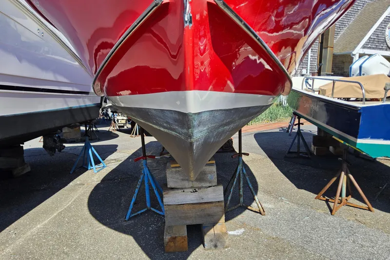 Slide: The Image of Red and white Grey Barn Boatworks North Shore 22 boat, 2010 model, on stands. - 21