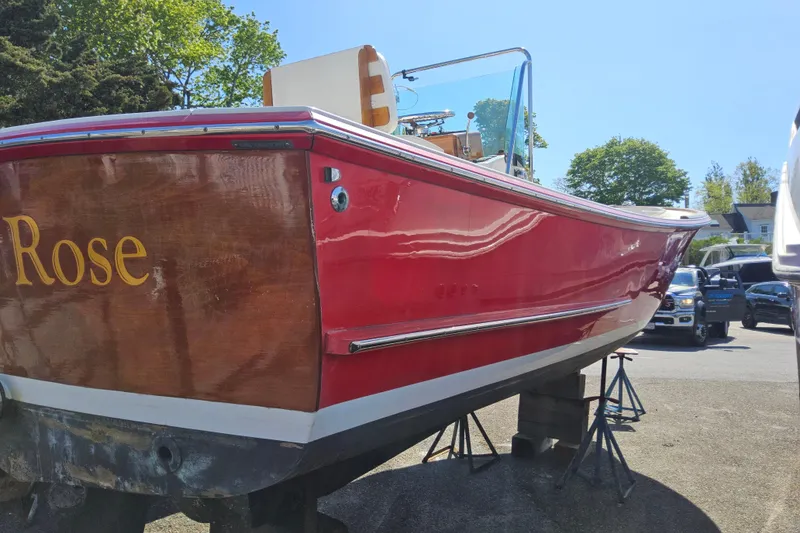 Slide: The Image of Red Grey Barn Boatworks North Shore 22, 2010 model, on stands in a sunny outdoor setting. - 3