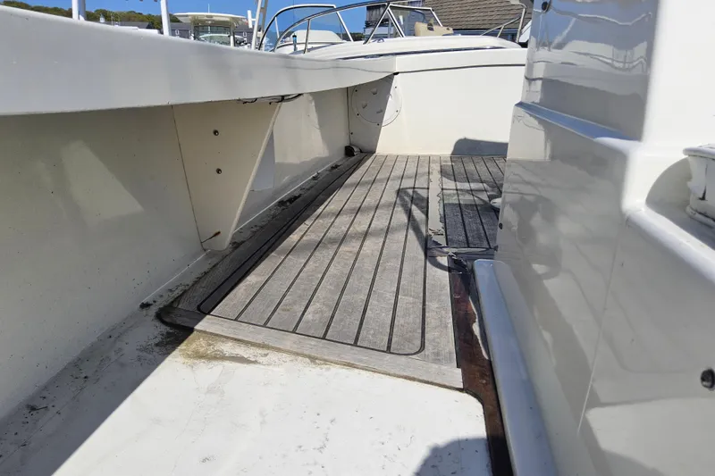 Slide: The Image of 2010 Grey Barn Boatworks North Shore 22 deck with wooden flooring. - 9