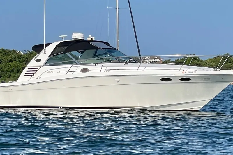 The Image of 1998 Sea Ray 370 Express Cruiser on calm water, showcasing sleek design and luxury features. - 0