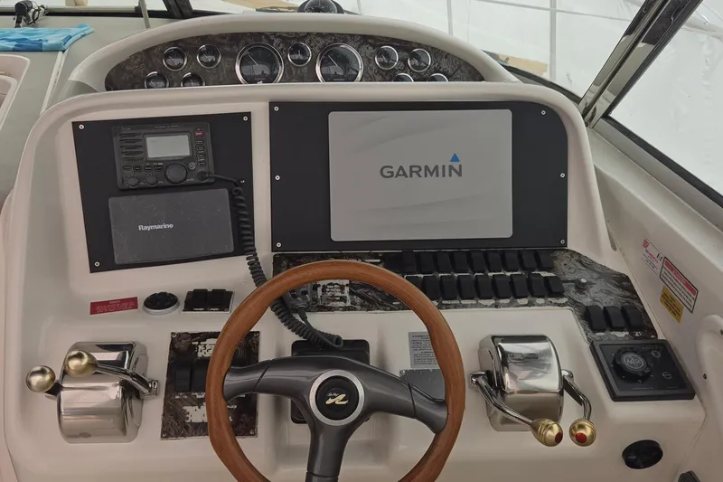 Slide: The Image of 1998 Sea Ray 370 Express Cruiser helm with Garmin navigation and Raymarine radio. - 10