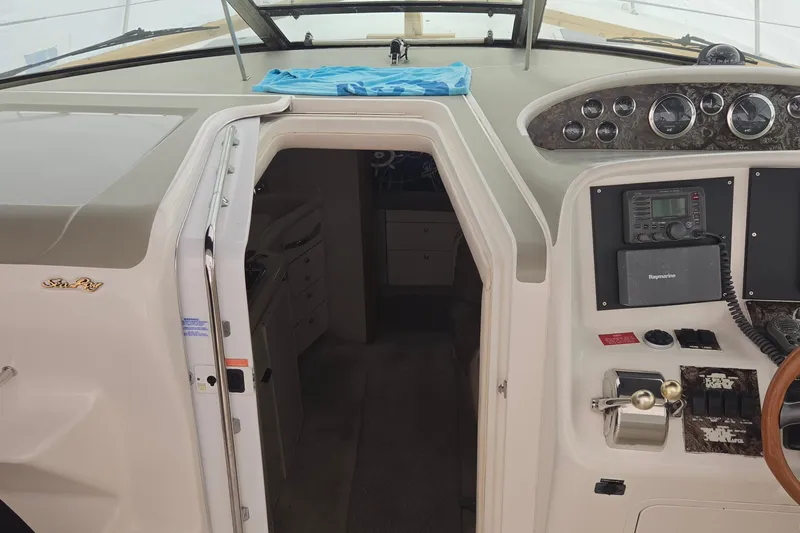 Slide: The Image of 1998 Sea Ray 370 Express Cruiser cockpit with navigation controls and cabin entrance. - 11