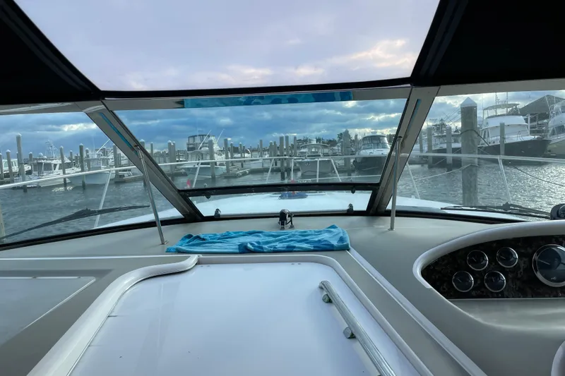 Slide: The Image of View from 1998 Sea Ray 370 Express Cruiser cockpit, overlooking marina with boats and cloudy sky. - 12
