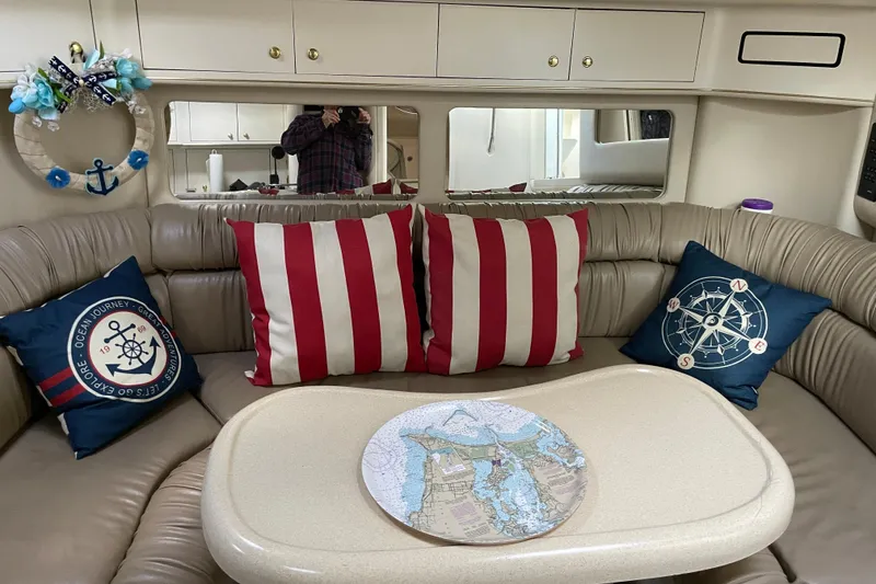 Slide: The Image of Interior of 1998 Sea Ray 370 Express Cruiser with nautical-themed pillows and decor. - 13