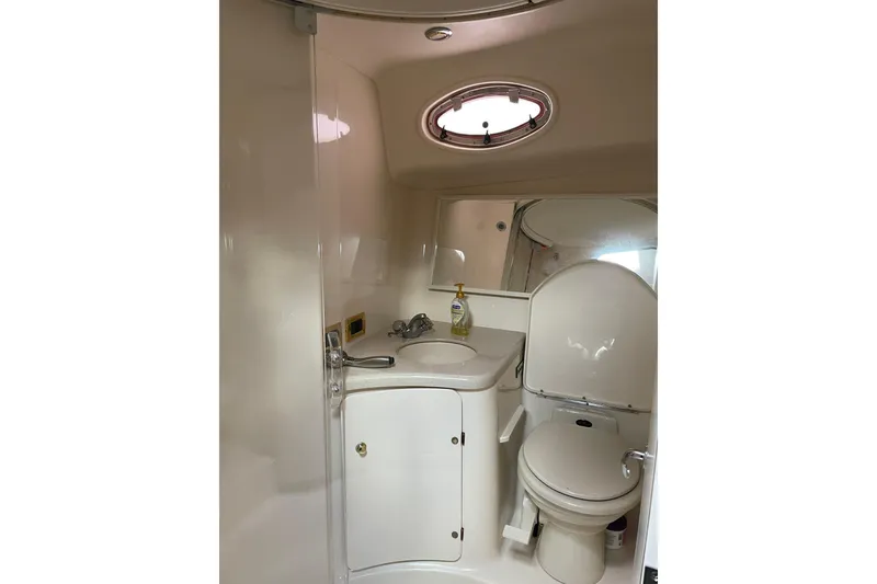 Slide: The Image of Bathroom interior of 1998 Sea Ray 370 Express Cruiser with sink and toilet. - 14