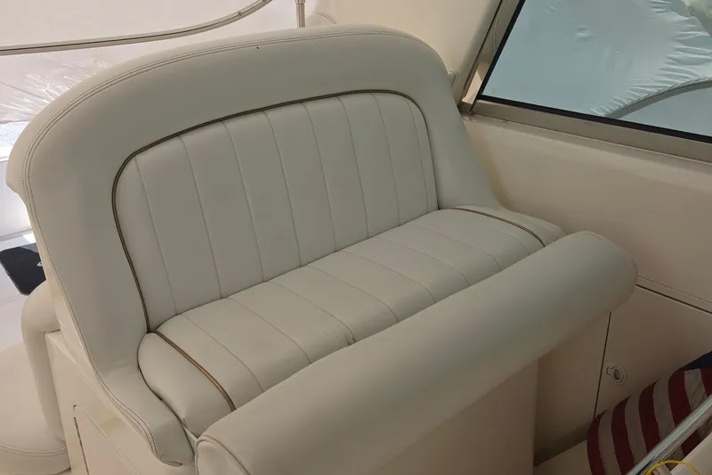 Slide: The Image of White leather seating on a 1998 Sea Ray 370 Express Cruiser boat interior. - 16
