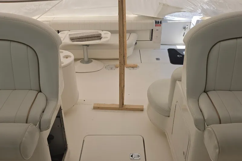 Slide: The Image of 1998 Sea Ray 370 Express Cruiser interior with white seating and table. - 17