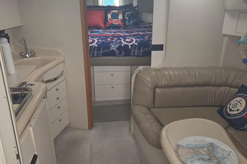 Slide: The Image of Interior of 1998 Sea Ray 370 Express Cruiser with cozy seating and nautical decor. - 19