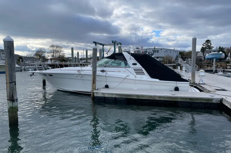 Slide: The Image of 1998 Sea Ray 370 Express Cruiser docked at marina under cloudy sky. - 2