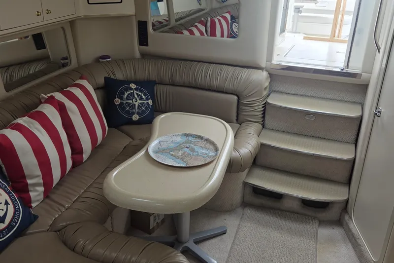 Slide: The Image of Interior of 1998 Sea Ray 370 Express Cruiser with cozy seating and nautical decor. - 21