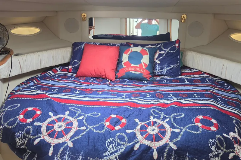 Slide: The Image of Nautical-themed bedroom in 1998 Sea Ray 370 Express Cruiser with decorative pillows and bedding. - 22