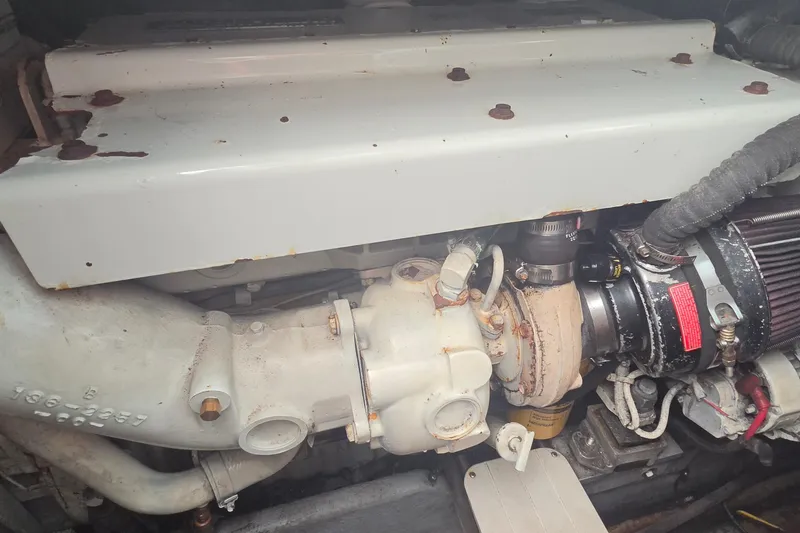 Slide: The Image of Engine compartment of a 1998 Sea Ray 370 Express Cruiser, showing mechanical components. - 23