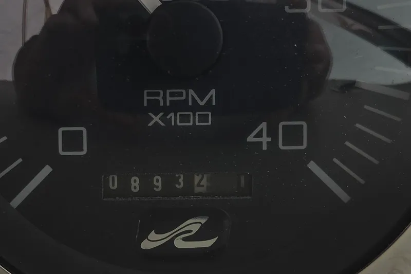 Slide: The Image of Close-up of a 1998 Sea Ray 370 Express Cruiser RPM gauge showing 893 hours. - 26