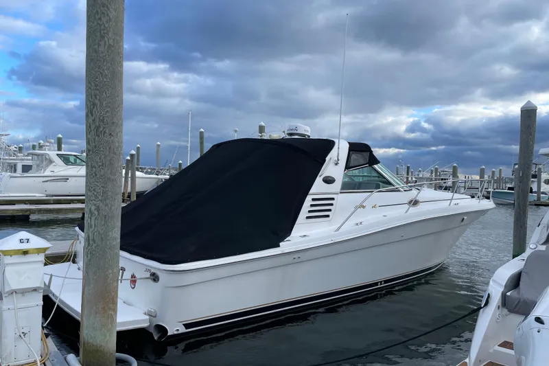 Slide: The Image of 1998 Sea Ray 370 Express Cruiser docked at marina under cloudy sky. - 3