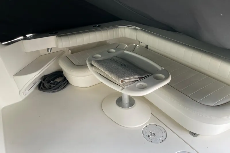 Slide: The Image of 1998 Sea Ray 370 Express Cruiser interior with white seating and table. - 6