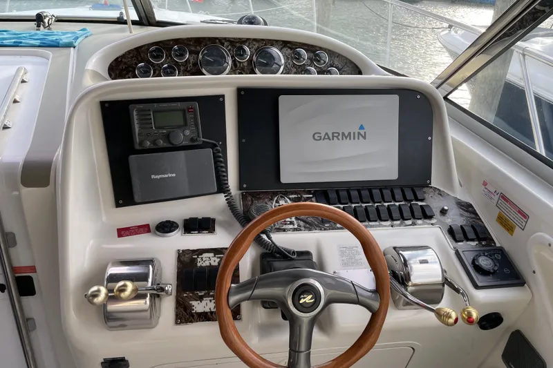 Slide: The Image of 1998 Sea Ray 370 Express Cruiser helm with Garmin navigation and Raymarine equipment. - 8
