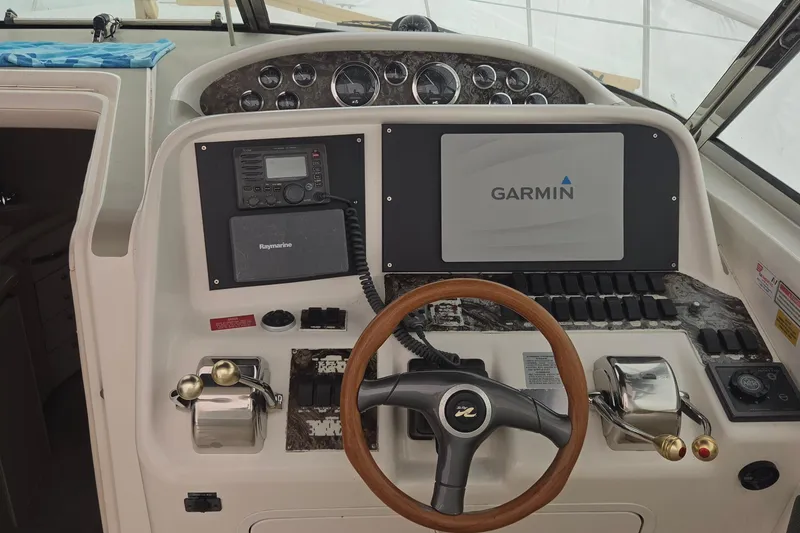Slide: The Image of 1998 Sea Ray 370 Express Cruiser helm with Garmin navigation system and Raymarine equipment. - 9