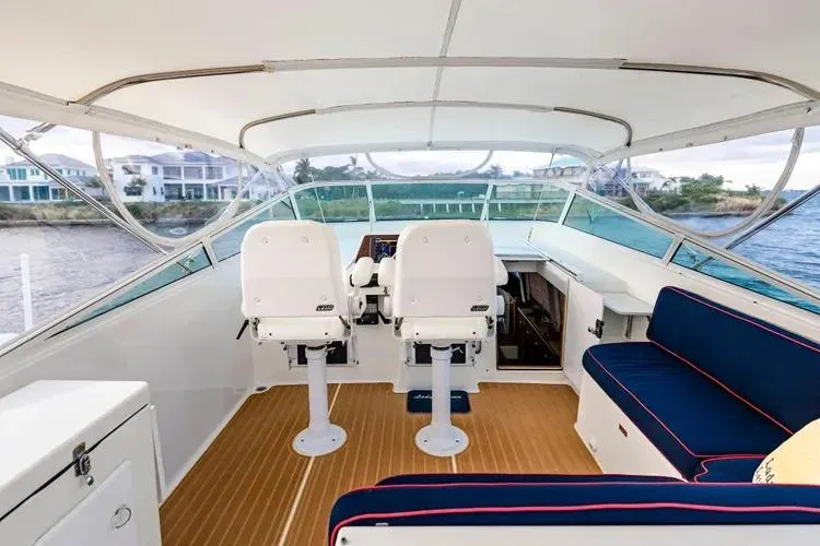 Slide: The Image of 2000 Pacific Mariner 65 Motoryacht helm with seating, overlooking waterfront homes. - 42