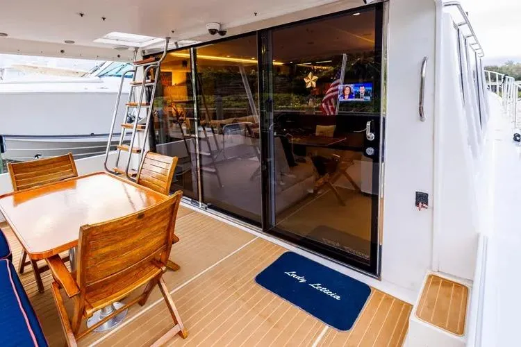 Slide: The Image of Outdoor deck of 2000 Pacific Mariner 65 Motoryacht with wooden dining set. - 43
