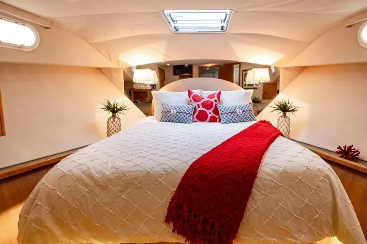 Slide: The Image of Luxurious bedroom interior of 2000 Pacific Mariner 65 Motoryacht with elegant bedding and decor. - 56