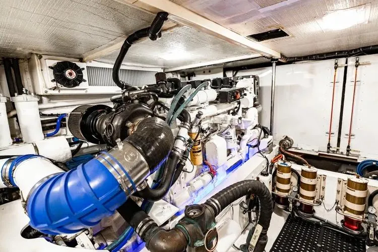 Slide: The Image of Engine room of a 2000 Pacific Mariner 65 Motoryacht, showcasing complex machinery and components. - 63