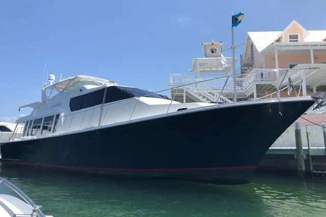 Slide: The Image of 2000 Pacific Mariner 65 Motoryacht docked near waterfront homes. - 67