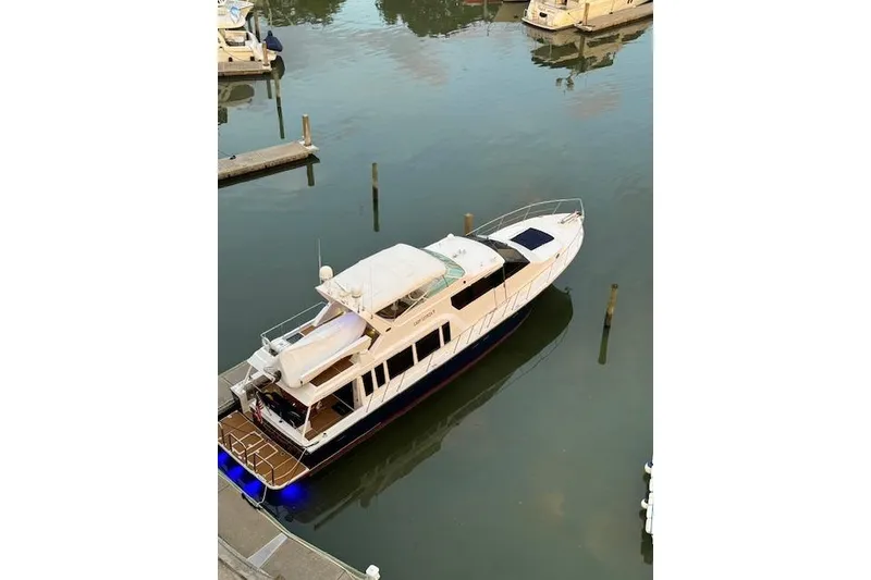 Slide: The Image of 2000 Pacific Mariner 65 Motoryacht docked in a marina, aerial view. - 70