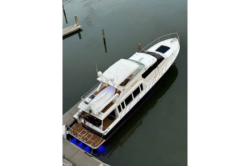 Slide: The Image of 2000 Pacific Mariner 65 Motoryacht docked in calm waters, aerial view. - 73