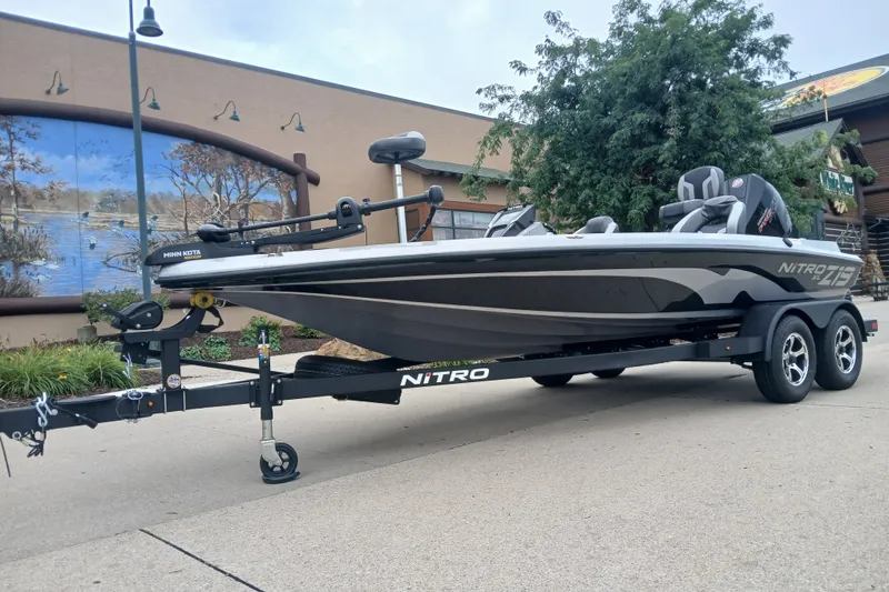 The Image of 2026 Nitro Z19 XL boat on trailer, parked outdoors near a mural. - 0