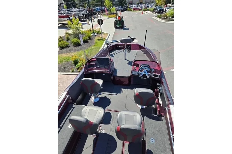 Slide: The Image of 2026 Nitro ZV20 boat interior with seating and steering wheel, parked outdoors. - 5