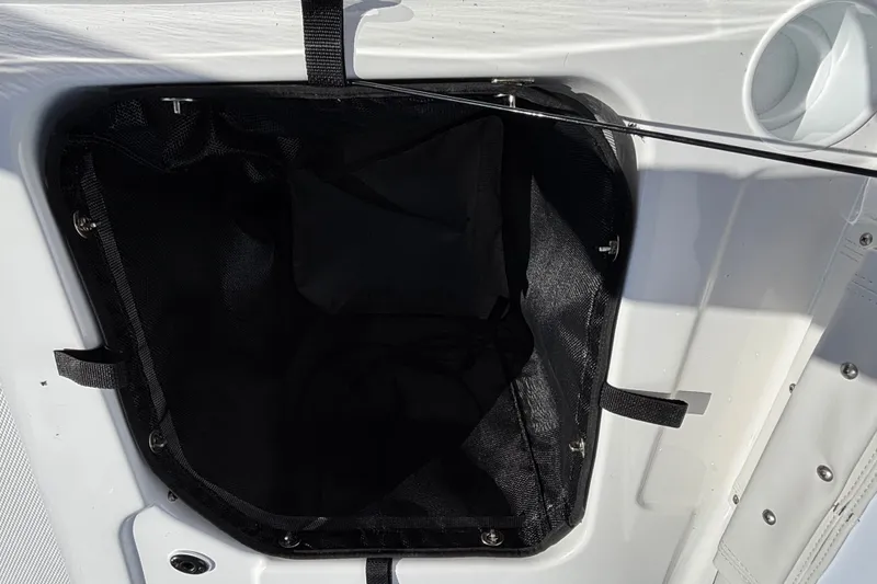 Slide: The Image of Storage compartment of 2026 Tahoe T21 boat, featuring a black interior and secure straps. - 20