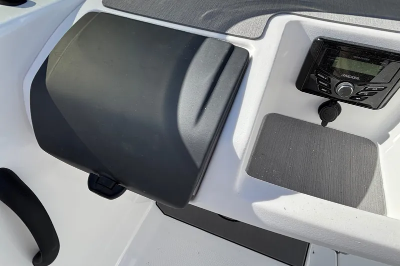 Slide: The Image of 2026 Tahoe T21 boat dashboard with audio system and storage compartment. - 17