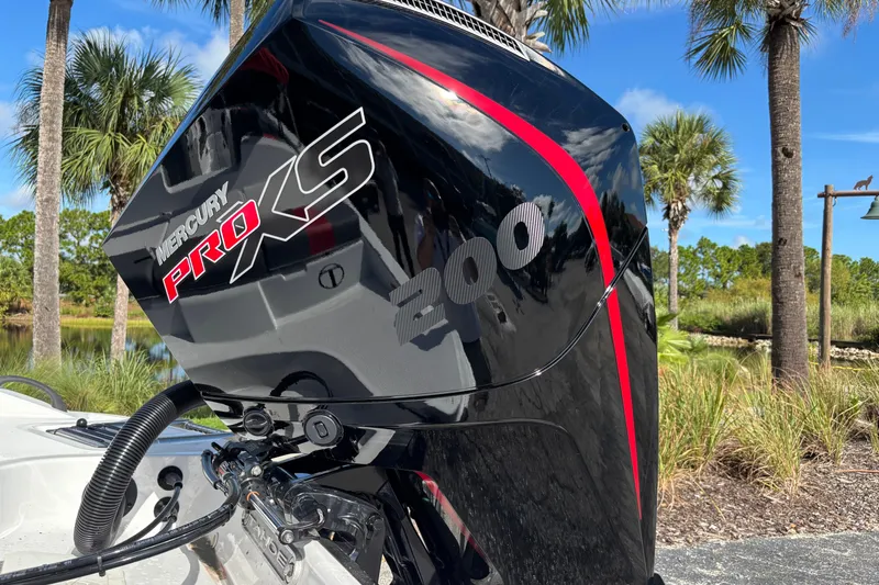 Slide: The Image of Mercury Pro XS 200 engine on 2026 Tahoe T21 boat, surrounded by palm trees. - 4