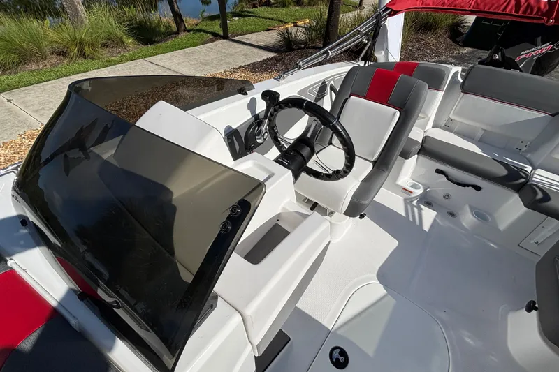 Slide: The Image of 2026 Tahoe T21 boat interior with steering wheel and seating, featuring modern design elements. - 13