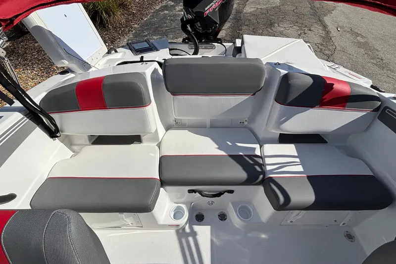 Slide: The Image of 2026 Tahoe T21 boat interior with gray and red cushioned seating. - 14