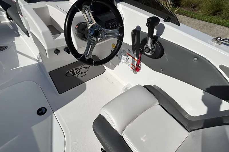 Slide: The Image of Interior of 2026 Tahoe T21 boat featuring steering wheel and control panel. - 16