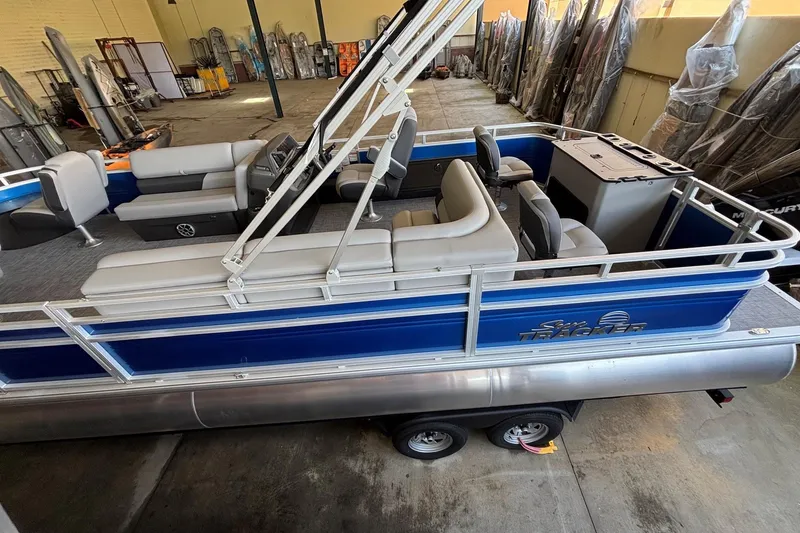 Slide: The Image of 2026 Sun Tracker Sportfish 24 XP3 pontoon boat with blue exterior and spacious seating. - 5