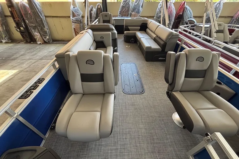 Slide: The Image of 2026 Sun Tracker Sportfish 24 XP3 pontoon boat interior with plush seating and spacious layout. - 4