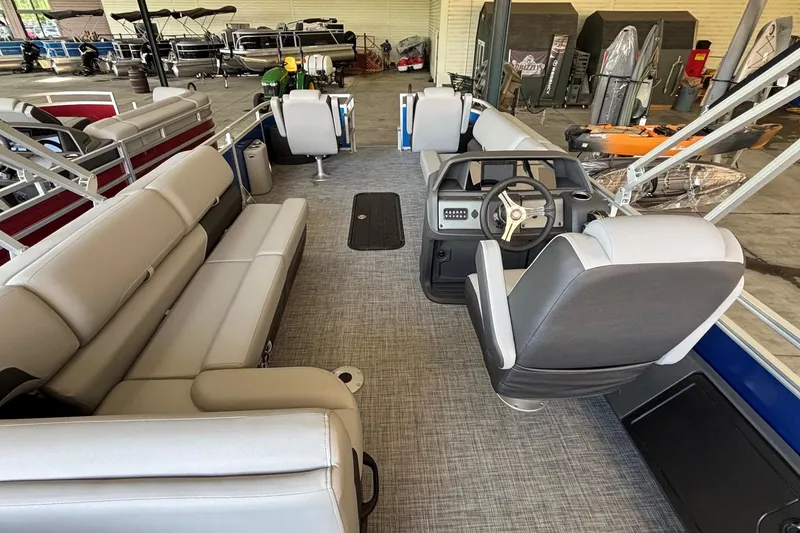 Slide: The Image of 2026 Sun Tracker Sportfish 24 XP3 pontoon boat interior with plush seating and modern helm. - 2